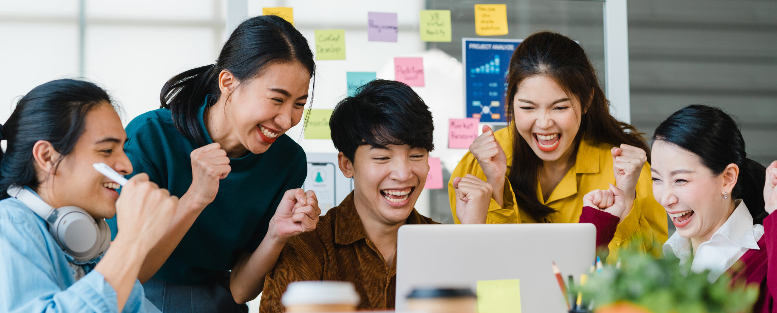 Group of Asia young creative people in smart casual wear discussing business celebrate giving five after dealing feeling happy and signing contract or agreement in office. Coworker teamwork concept.